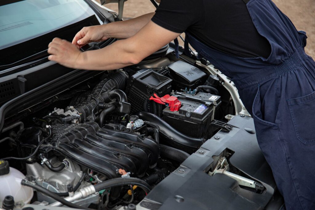 person fixing a car
